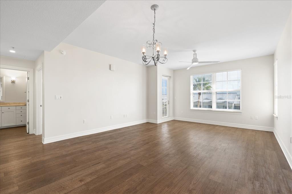 536 Bahia Beach Boulevard, Unit 431C Ruskin, FL 33570 - Photo 7 of 27 a view of an empty room with wooden floor and a window