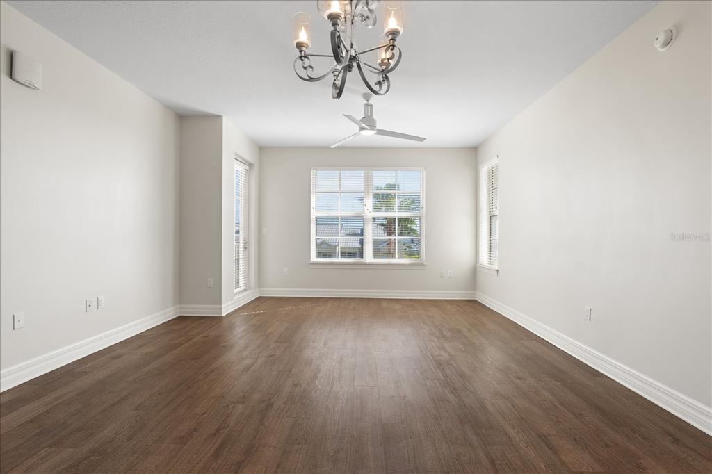536 Bahia Beach Boulevard, Unit 431C Ruskin, FL 33570 - Photo 8 of 27 a view of empty room with wooden floor and fan