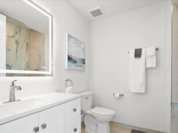 a bedroom with a bed and a painting on the wall