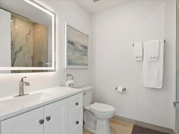 a bathroom with a sink toilet and shower