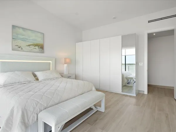 a bedroom with a bed and a ceiling fan