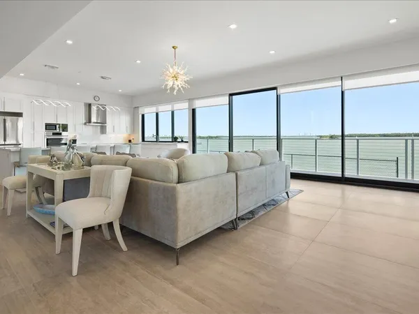 a living room with furniture and a chandelier