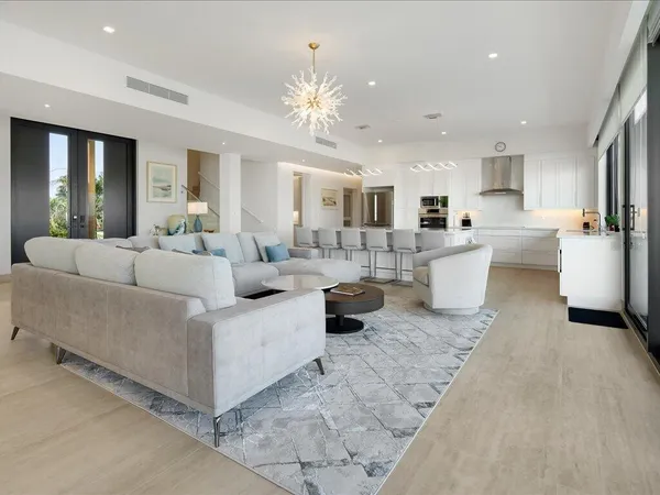 a living room with furniture and a chandelier