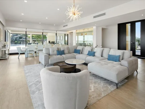 a large white kitchen with lots of counter space and appliances