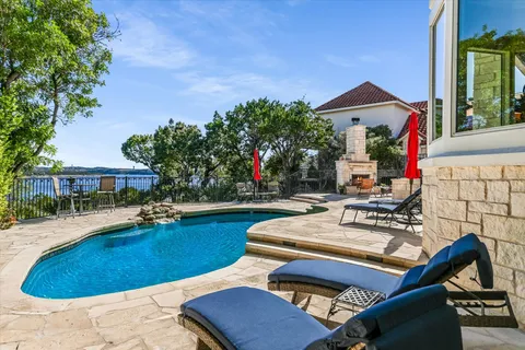 a view of a house with swimming pool and sitting area