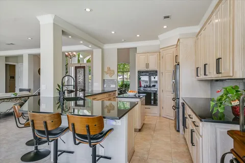 a very nice looking open dining room with kitchen island furniture a rug and a view of kitchen