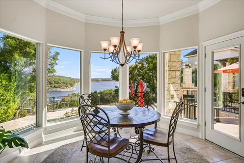 a view of a dining room with furniture a chandelier and wooden floor