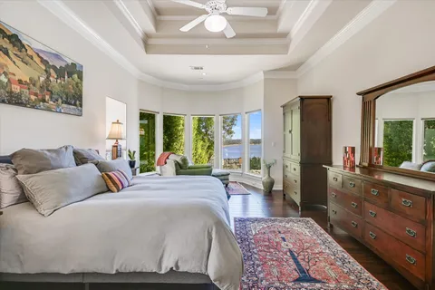a bedroom with a large bed and a chandelier