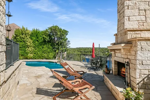 a backyard of a house with fountain plants and outdoor seating