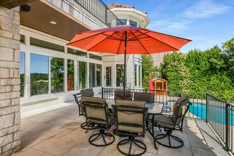 a view of an outdoor sitting area with furniture and umbrella