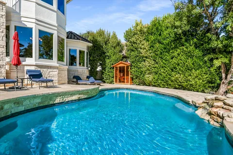 a swimming pool with outdoor seating and yard
