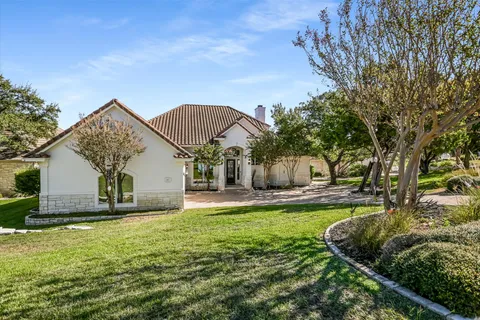 a view of a house with a yard and sitting area