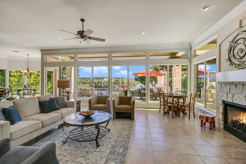 a living room with fireplace furniture and a large window