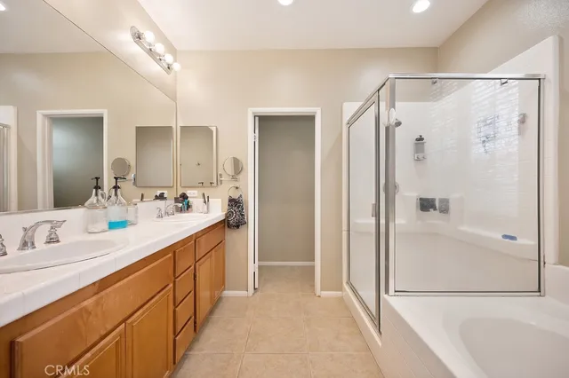 a spacious bathroom with a double vanity sink shower and a mirror