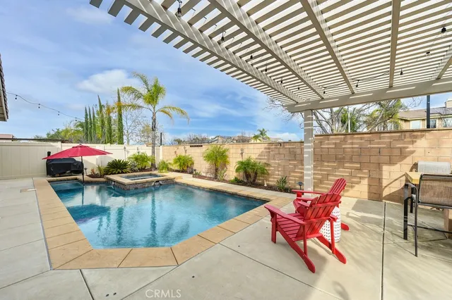 swimming pool view with a seating space