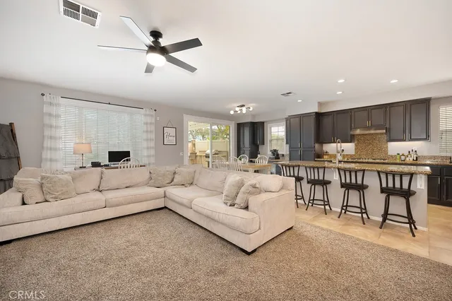a living room with furniture and kitchen view