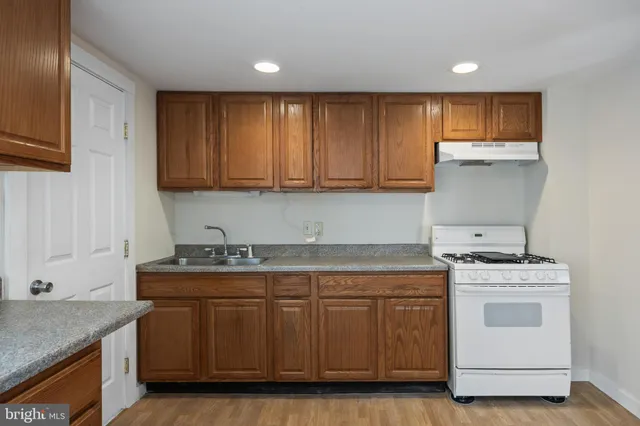 a kitchen with a refrigerator a stove and a sink