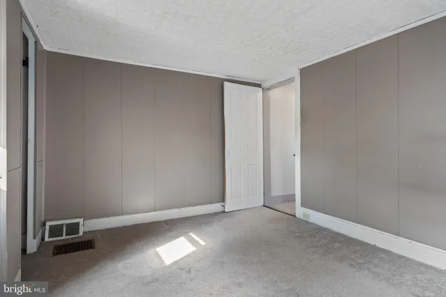 an empty room with closet area