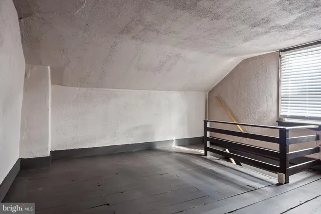 a picture of a bench in front of a wall