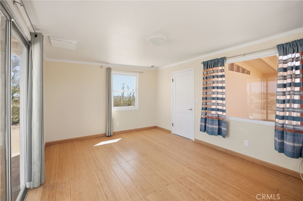 66270 Brant Crossing Road Joshua Tree, CA 92252 - Photo 13 of 46 wooden floor in an empty room with a window