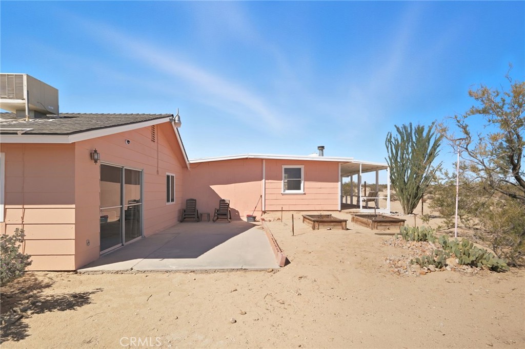 66270 Brant Crossing Road Joshua Tree, CA 92252 - Photo 16 of 46 a view of a house with a yard
