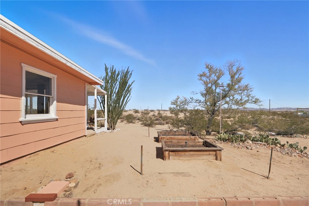 66270 Brant Crossing Road Joshua Tree, CA 92252 - Photo 19 of 46 a view of a terrace with a bench
