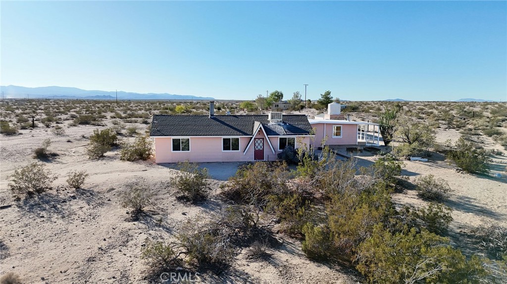 66270 Brant Crossing Road Joshua Tree, CA 92252 - Photo 2 of 46 a view of a house with a yard