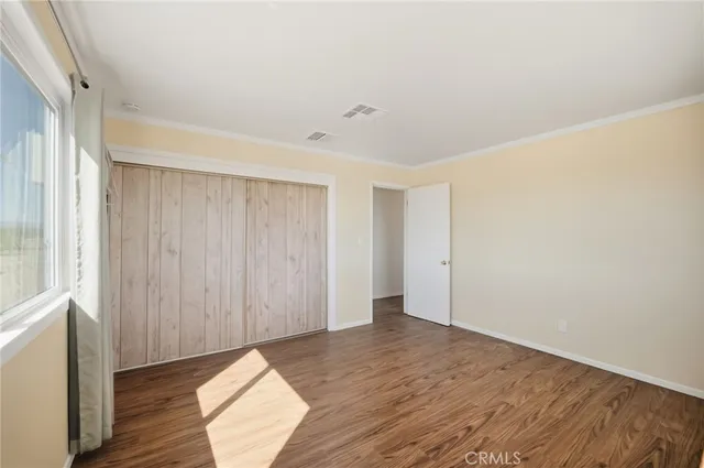 a view of hallway with wooden floor
