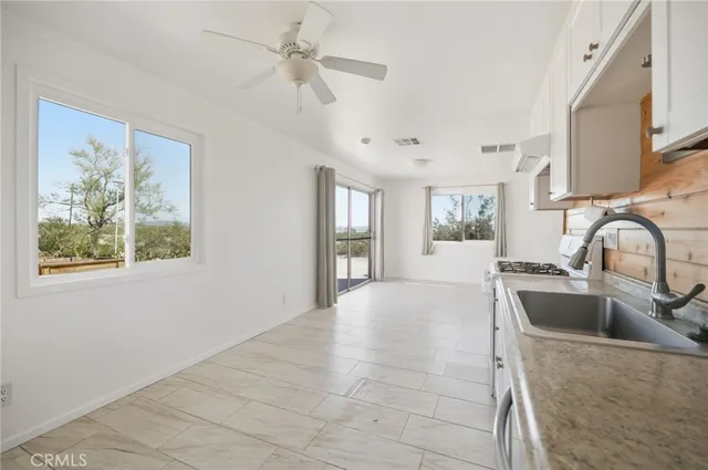 a view of empty room with a fireplace and wooden floor