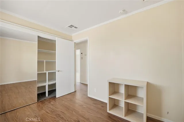 a room view with wooden floor and window