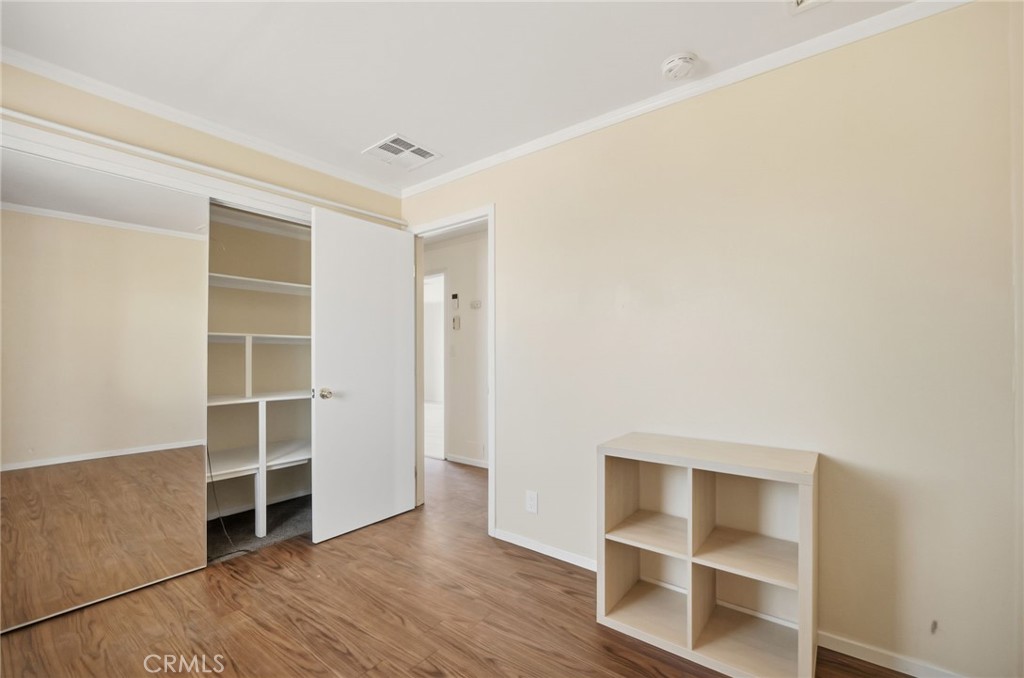 66270 Brant Crossing Road Joshua Tree, CA 92252 - Photo 31 of 46 a view of an empty room with wooden floor and closet