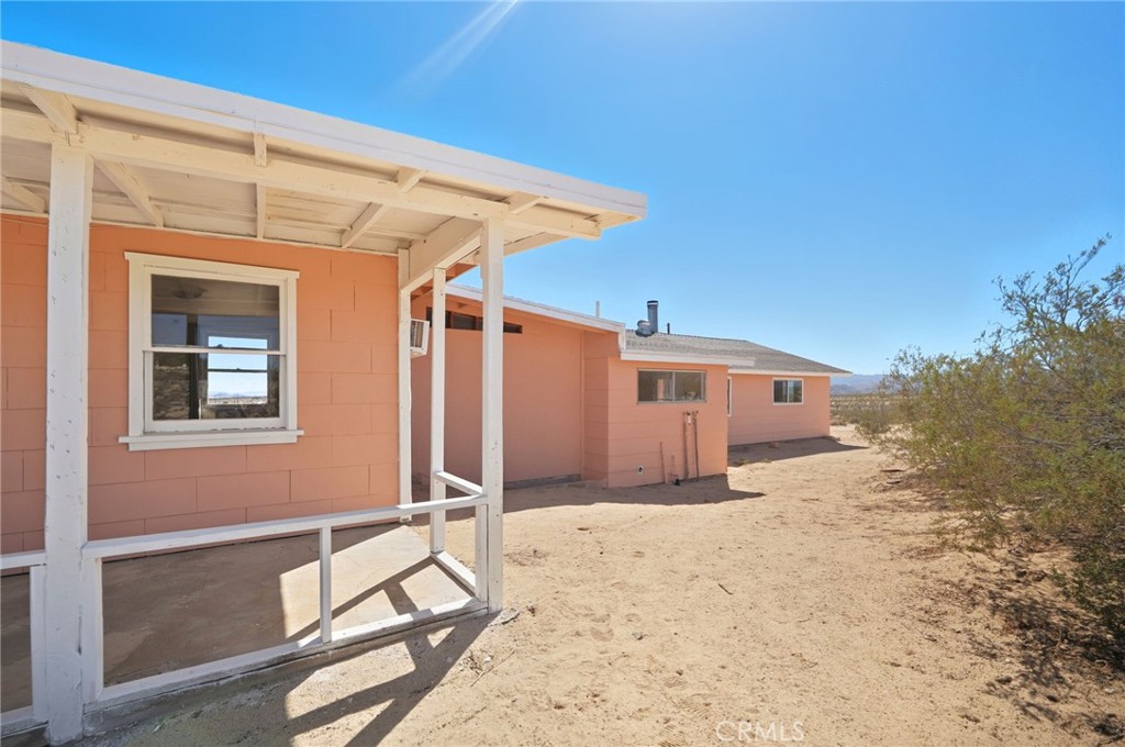 66270 Brant Crossing Road Joshua Tree, CA 92252 - Photo 33 of 46 a view of a house with a backyard