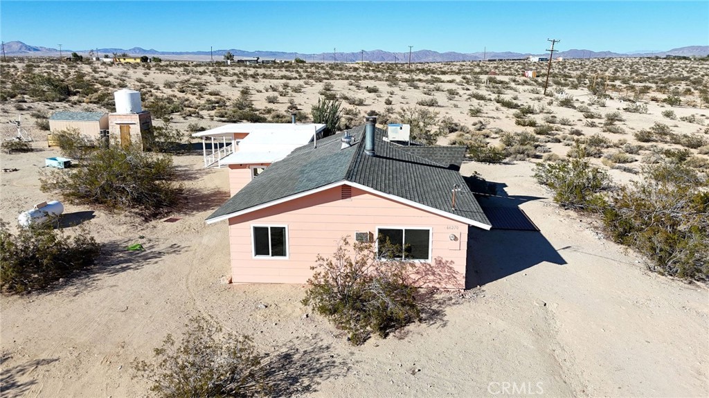 66270 Brant Crossing Road Joshua Tree, CA 92252 - Photo 38 of 46 a view of a house with a yard