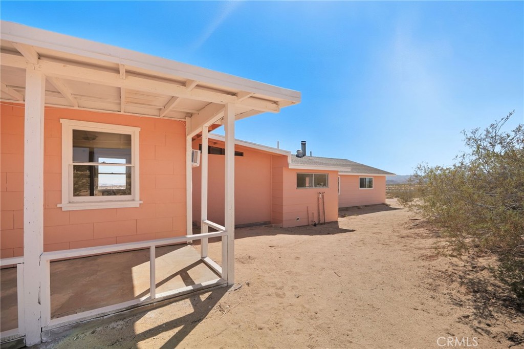 66270 Brant Crossing Road Joshua Tree, CA 92252 - Photo 6 of 46 a view of a house with a backyard