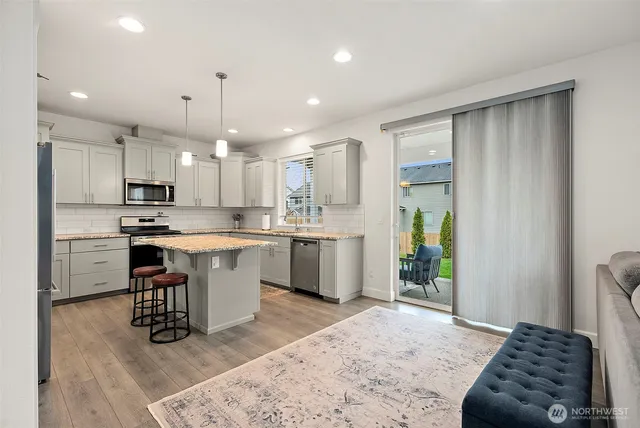 a kitchen with a refrigerator and a sink