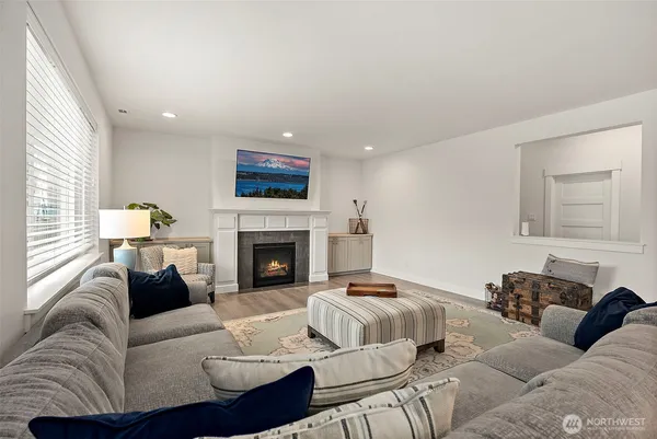 a living room with furniture a fireplace and a flat screen tv
