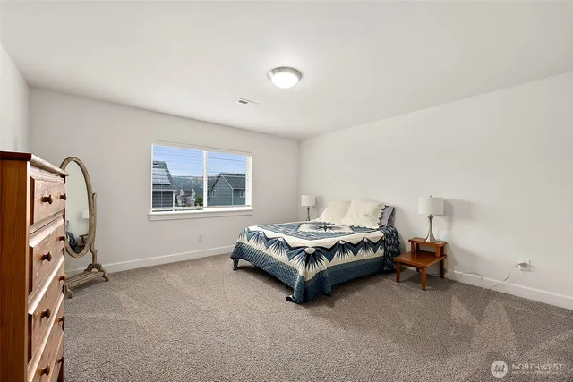 a spacious bedroom with a bed and a window