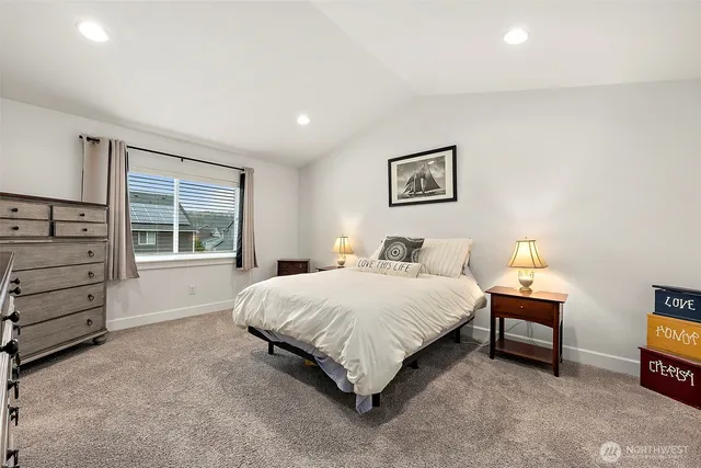 a bedroom with a bed and a couch