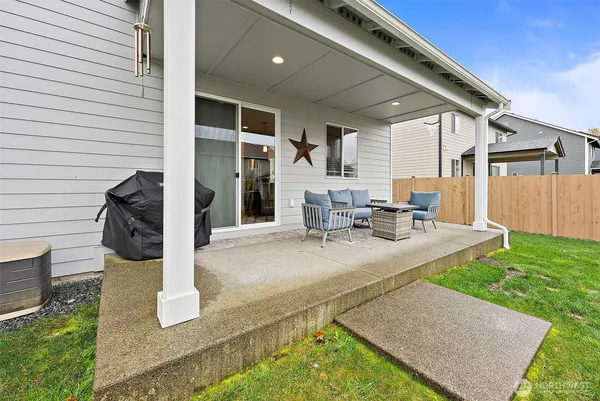 a view of a patio with table and chairs with wooden fence