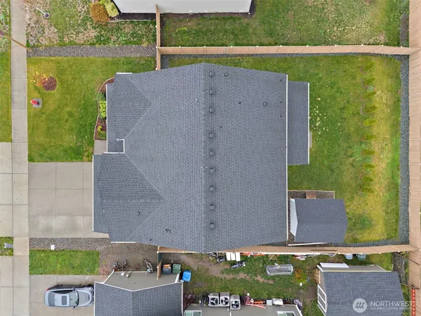 an aerial view of a house with a yard