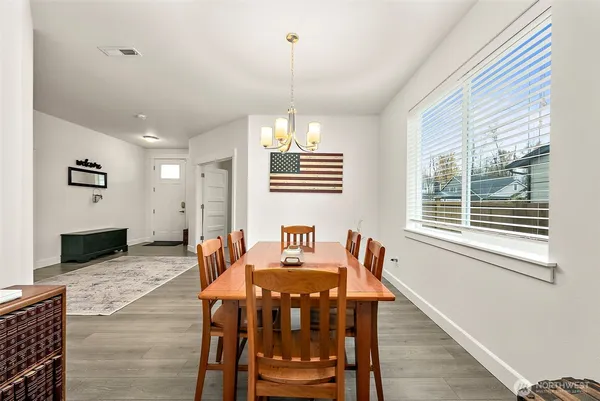 a view of a dining room with furniture window and wooden floor