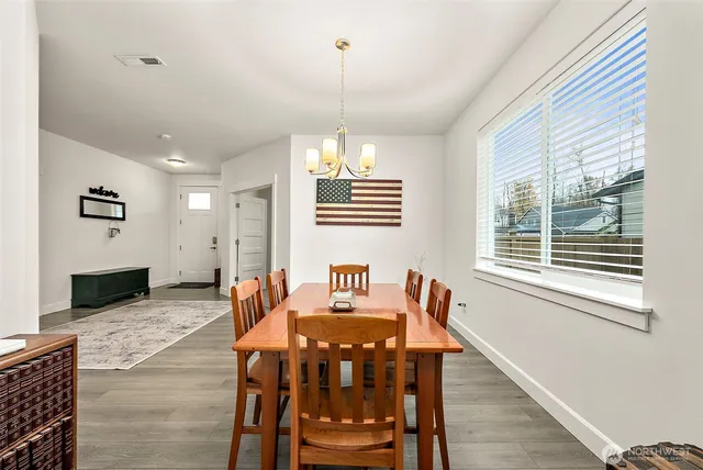 a view of a dining room with furniture window and wooden floor