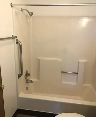 a bathroom with a bathtub and a shower