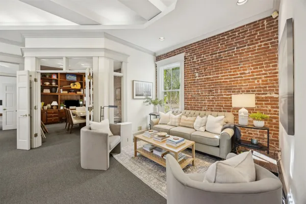 a view of a dining room and livingroom with furniture