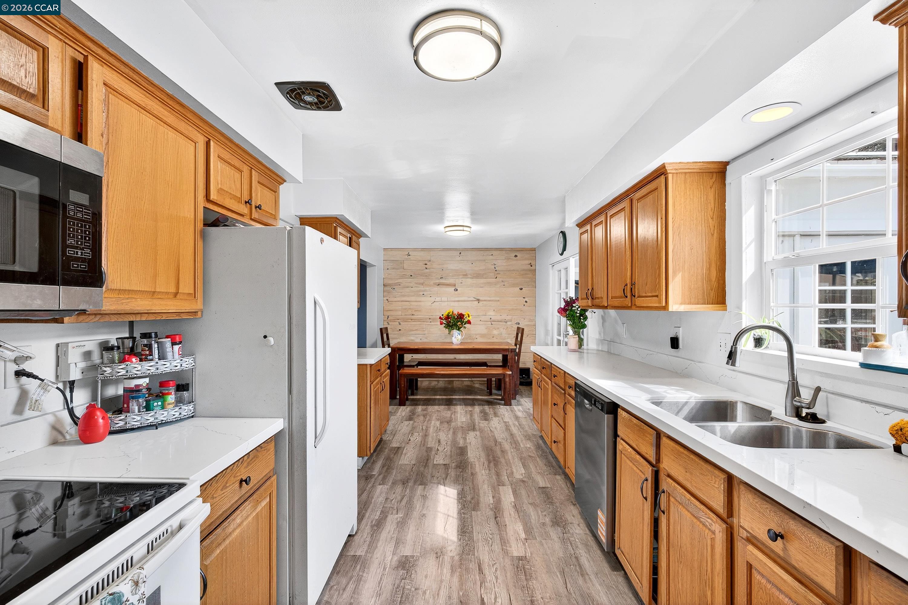 2312 Granada Court Pinole, CA 94564 - Photo 14 of 60 a kitchen with stainless steel appliances granite countertop a sink stove and refrigerator
