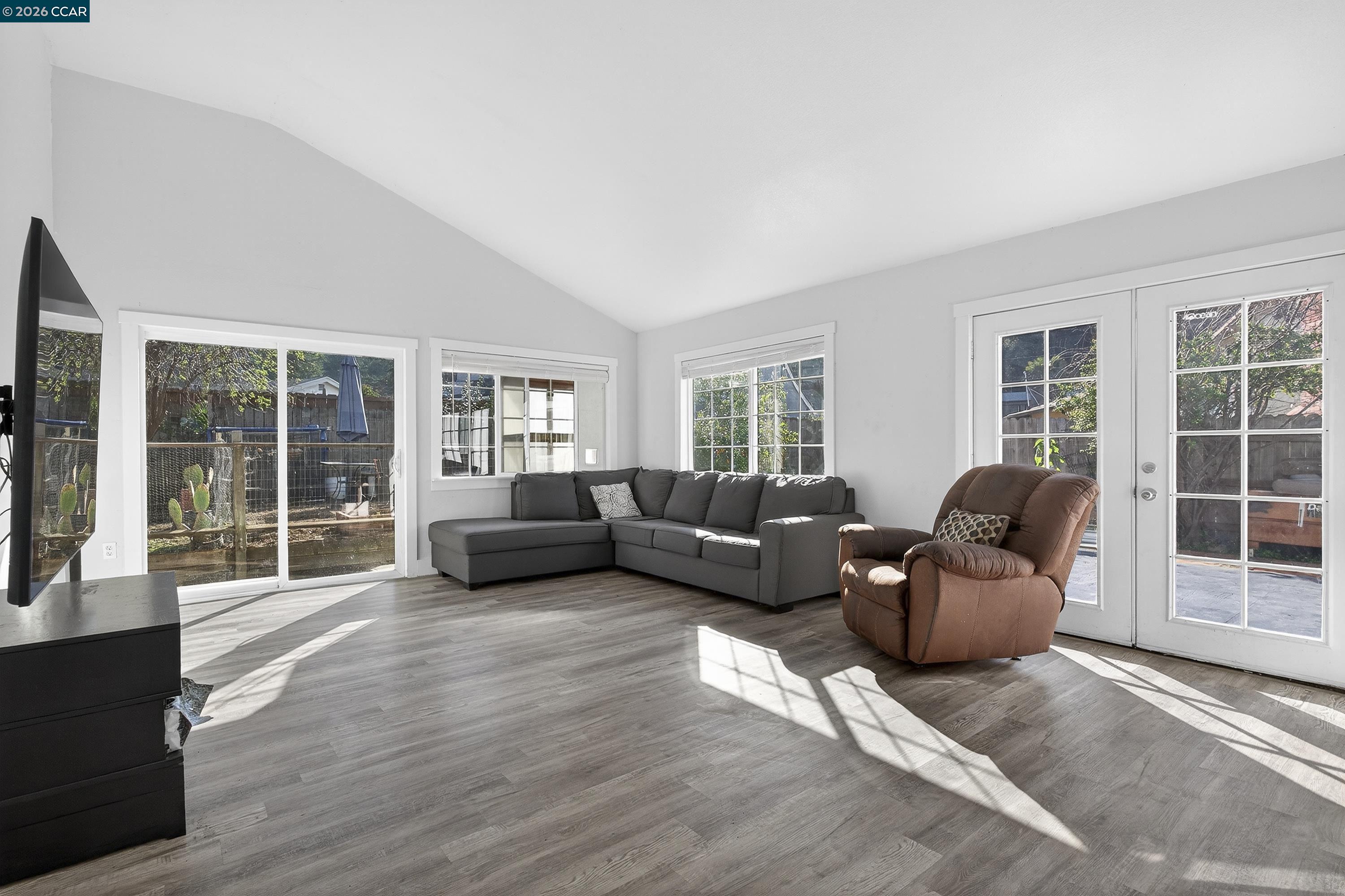 2312 Granada Court Pinole, CA 94564 - Photo 17 of 60 a living room with furniture and large windows