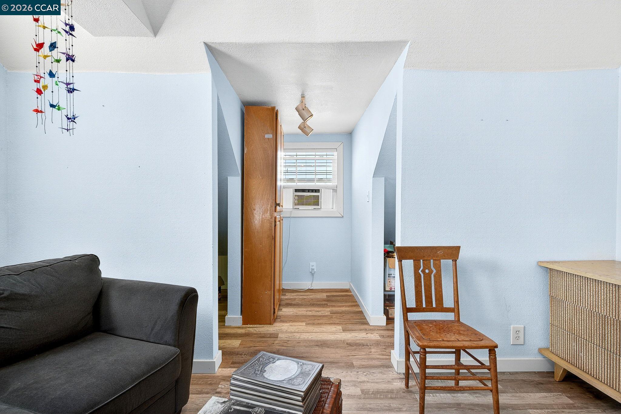 2312 Granada Court Pinole, CA 94564 - Photo 26 of 60 a living room with furniture and a wooden floor