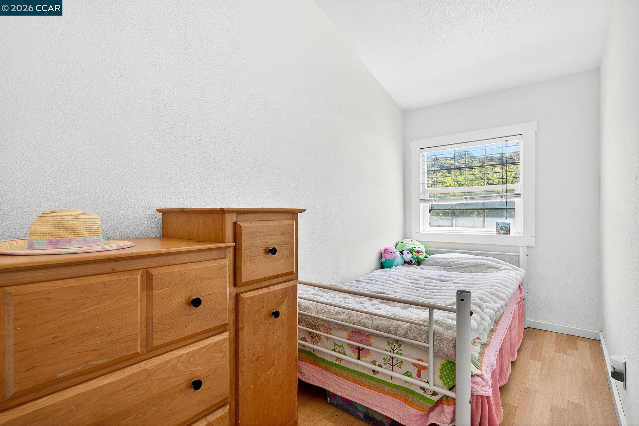 2312 Granada Court Pinole, CA 94564 - Photo 32 of 60 a bedroom with a bed and window