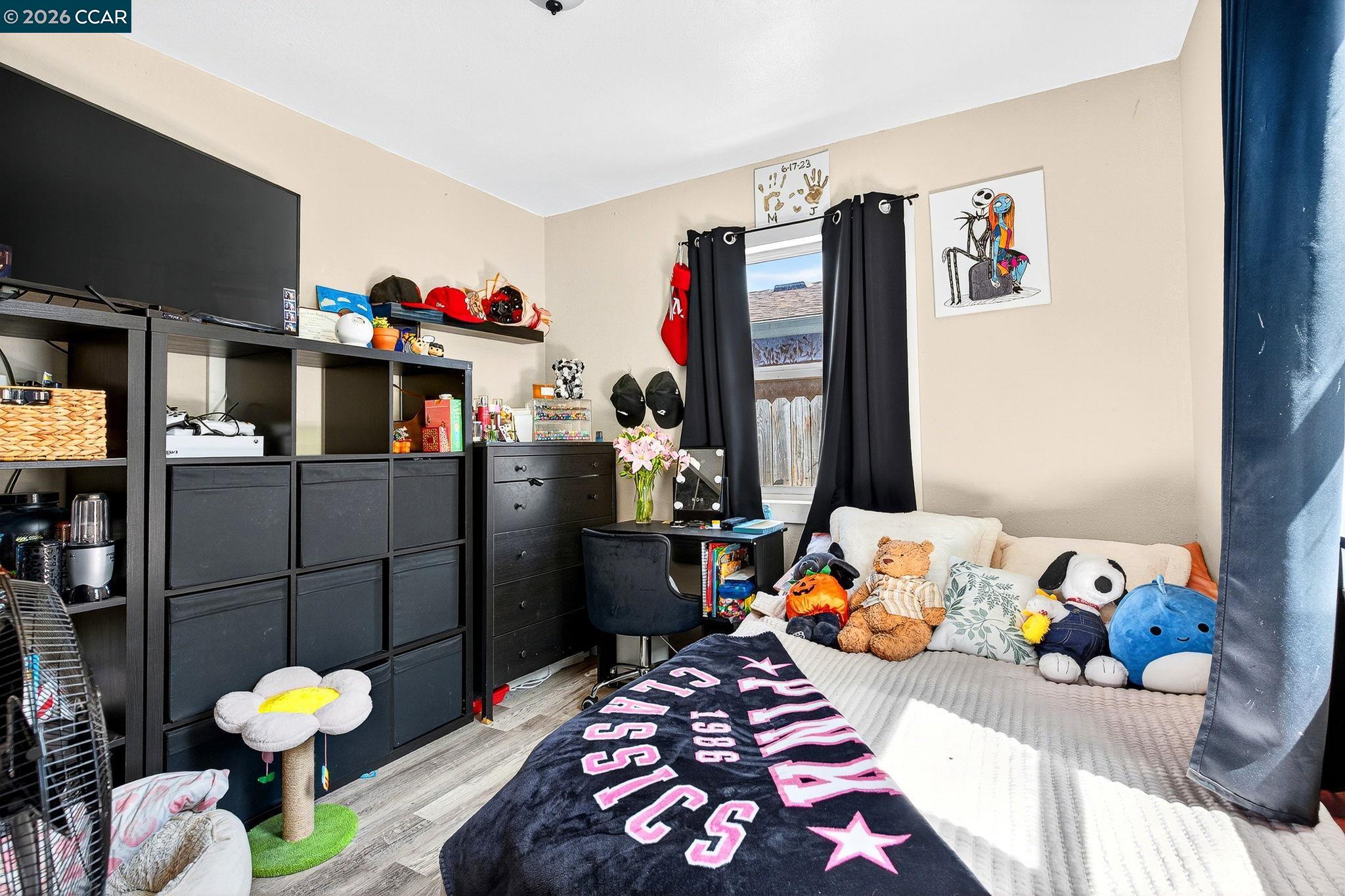 2312 Granada Court Pinole, CA 94564 - Photo 41 of 60 a bedroom with a bed and a flat screen tv