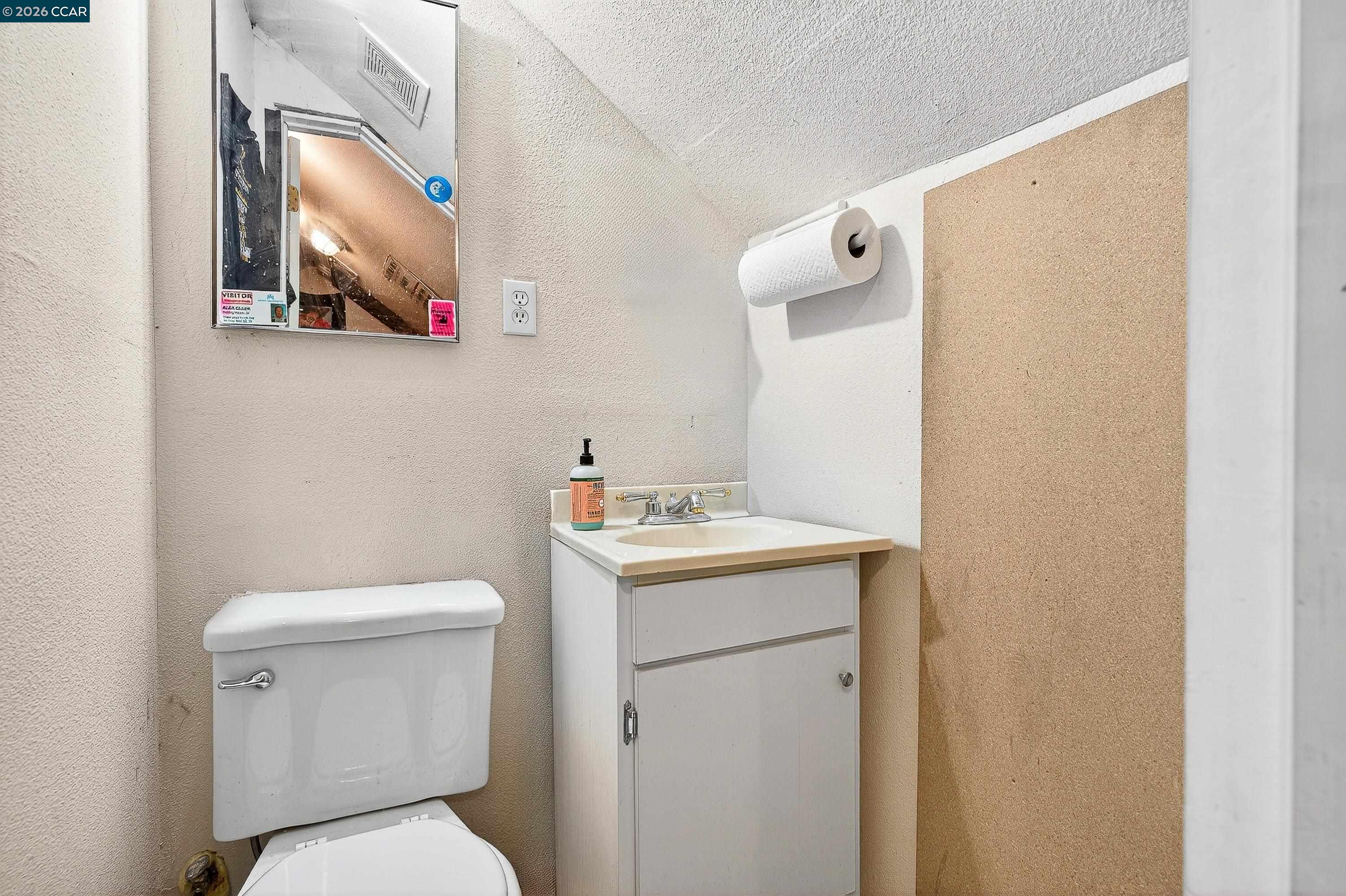 2312 Granada Court Pinole, CA 94564 - Photo 43 of 60 a white toilet sitting next to a bathroom sink